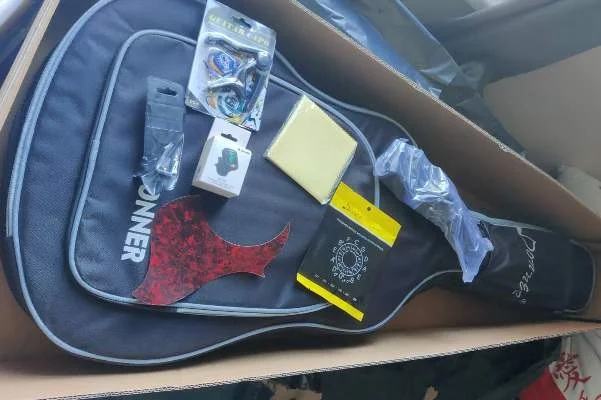 Donner guitar picks, gig bag, clip on tuner, etc.