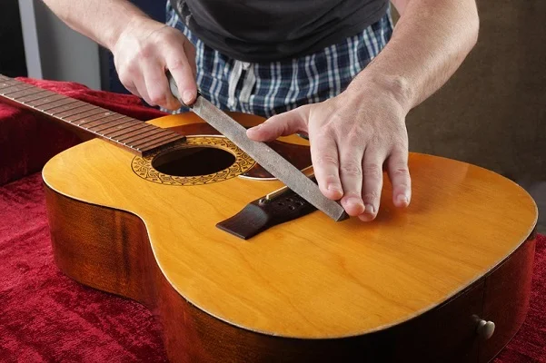 Lower action on acoustic guitar