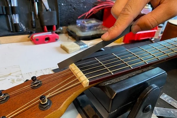 How to adjust the action on an acoustic guitar